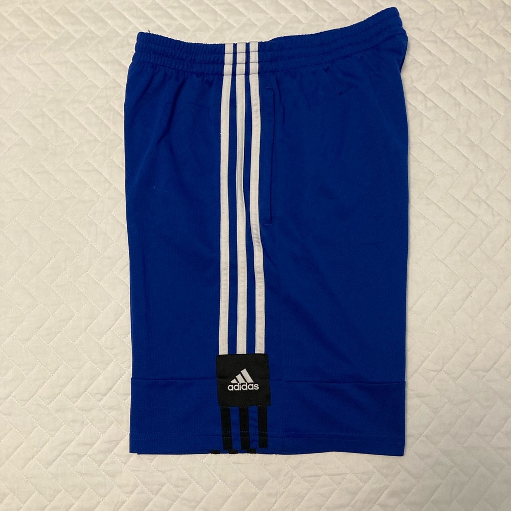 Royal blue Adidas boy’s gym shorts with some flaws.